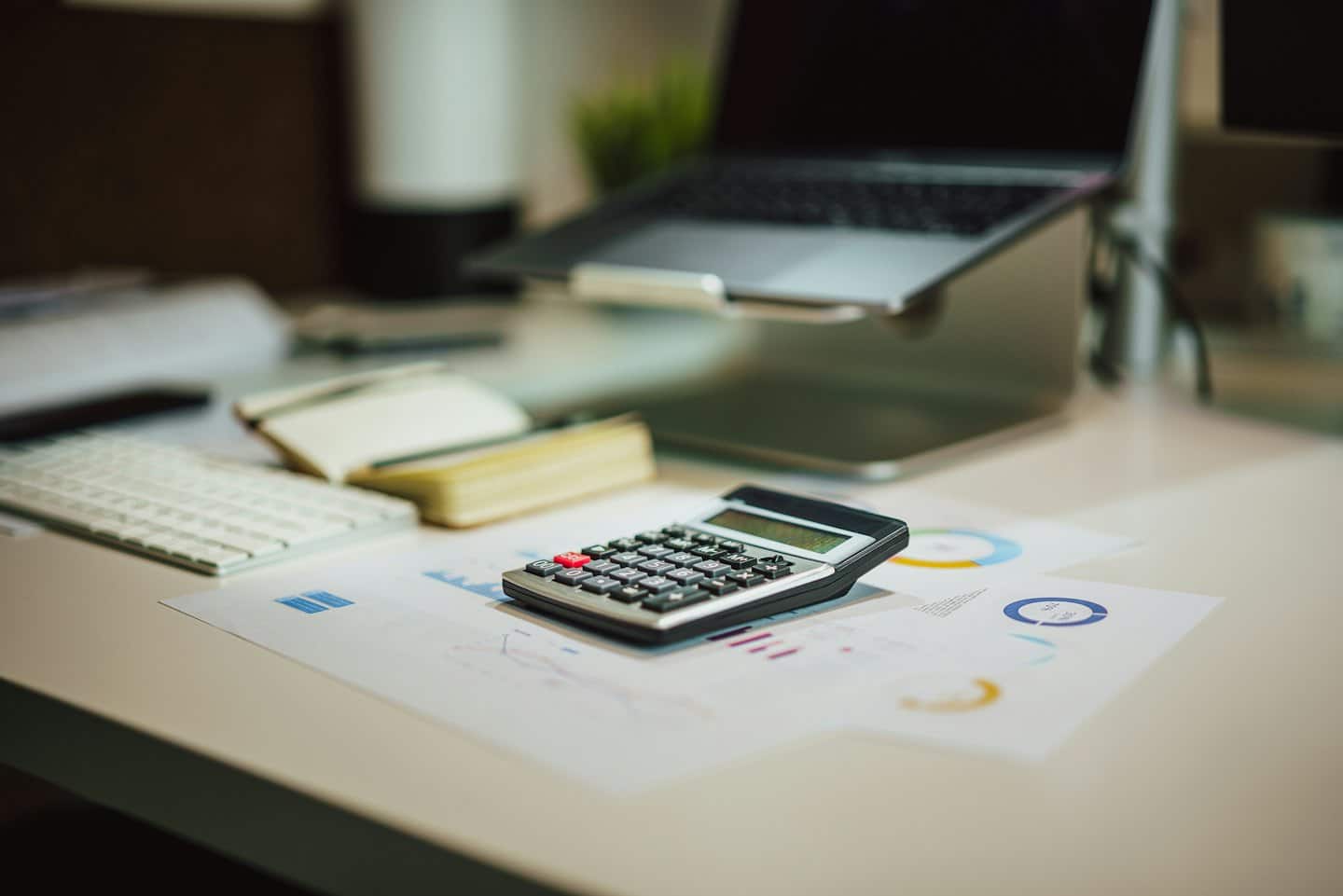 Calculator on financial documents at an office desk.